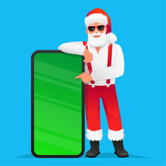 Cool trendy Santa Claus in sunglasses points to a big phone. Santa in a white shirt with suspenders rests his hand on a huge smartphone with a chroma key. New Year's concept