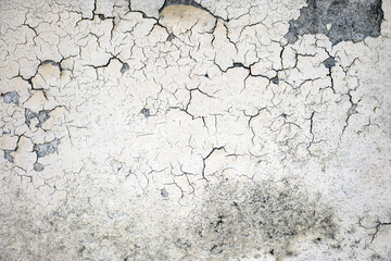 Cracked plaster on the wall of the house. Background