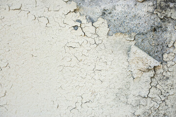 Cracked plaster on the wall of the house. Background