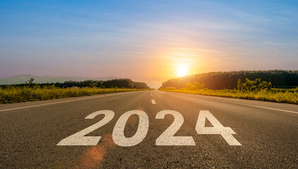 2024 written on highway road. Empty asphalt road and beautiful sunrise sky background. Concept of...