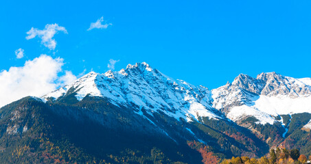 The mountain view of alpine as snow-capped mount peaks in Winter mountains scene