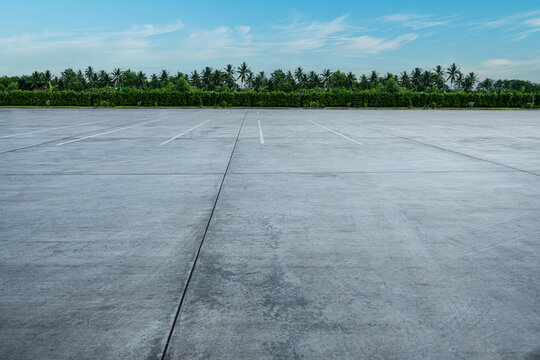 Empty parking lot and blue sky background. Parking outdoor in public park