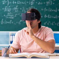 Young male student in the classroom