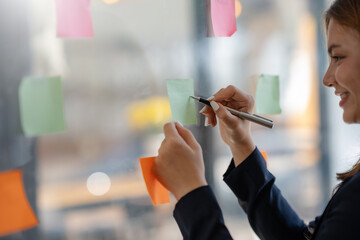 Close-up of hand Businesswoman writing sticky note to her mirror at the office. Business woman...