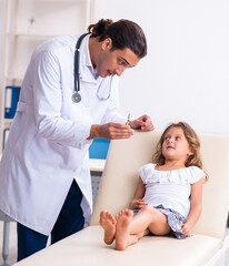 Young doctor pediatrician with small girl