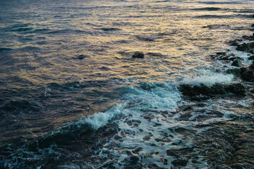 Ocean sunset from rocky shore, Jeju island vacation