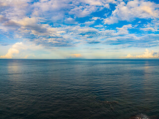 Obraz premium Amazing sunset or sunrise sky over sea landscape,Beautiful colorful light of nature seascape background,Drone aerial view ocean background