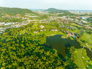 Aerial view of beautiful green golf field fairway and putting green, Top down image for sport...