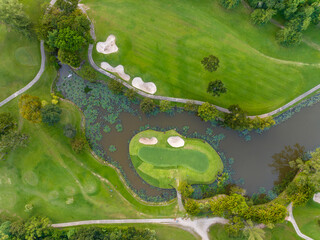 Aerial view of beautiful green golf field fairway and putting green, Top down image for sport background and travel nature background, Amazing  green nature view