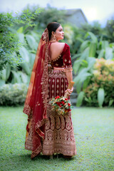 Asian woman in traditional costume,  Maroon embroidered velvet semi stitched lehenga