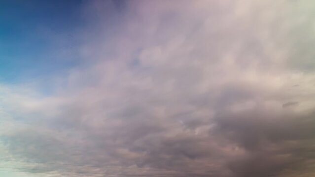 Blurred clouds moving rapidly across the sky in a time-lapse shot.