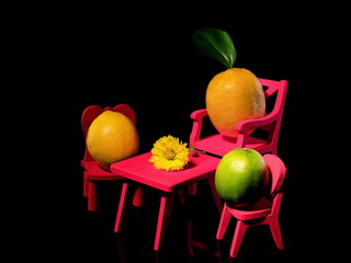 Composition with three lemons at the table on a black background