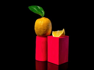 Composition with lemon on a stand on a black background