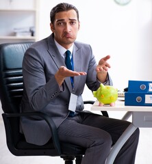 Young male accountant working in the office