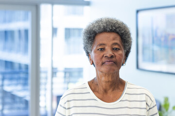 Portrait of african american senior woman in hospital waiting room with copy space