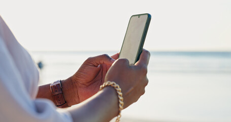 Closeup, beach and person with a smartphone, typing and connection with vacation, internet and...