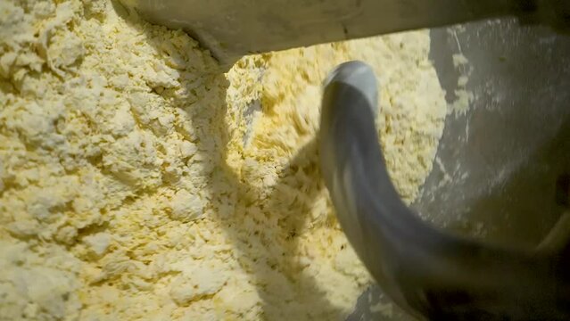 Dough kneading machine, kneads flour and eggs. Slow motion video, portrait video
