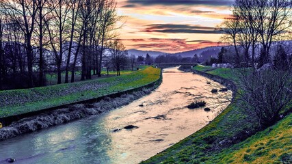 Sunset over a small river Ropa  in the Gorlice, Poland.