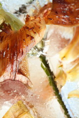 Frozen flowers lily in ice cube