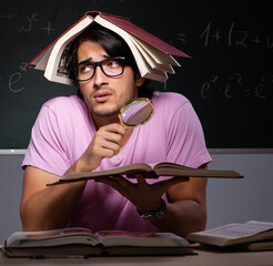 Young male student sitting in classroom
