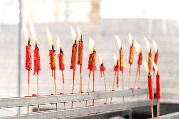 A row of prayer candles in a Buddhist temple, Bangkok, Thailand