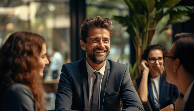 A Group Of Employees Smiling And Chatting With Their HR Representative, Who Is Explaining The Benefits Of A Company Retirement Plan.