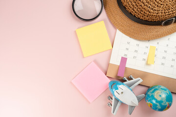 Flat lay concept of travel accessories vacation trip and long summer weekend planning on pink table with copy space for text background.