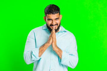 Sneaky cunning Indian young man with tricky face gesticulating and scheming evil plan, thinking...