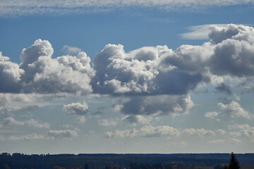 Cumulus clouds and field. Horizon and sky with field