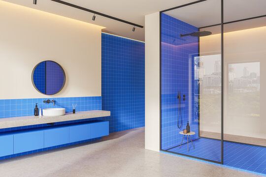 Stylish colorful hotel bathroom interior with sink and glass shower
