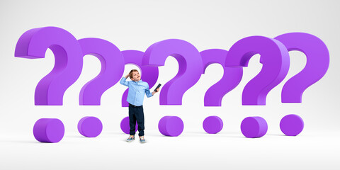 Thoughtful child with phone standing near big purple question marks in row