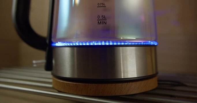 SWITCH ON THE ELECTRIC KETTLE WITH BLUE LIGHTS ON INSIDE CLOSE-UP | BOILING WATER IN THE MODERN KETTLE | 4K 12-BIT FOOTAGE