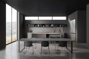 Grey home kitchen interior with dining and cooking space near panoramic window