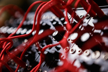 Analog modular synthesizer board connected with wires in sound recording studio. Professional synth device for electronic music production