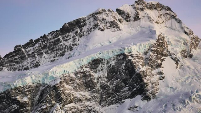 glacier covered mountain peak right before sunset