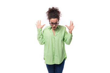 young stylish caucasian secretary woman with black curly hair in glasses and light green shirt on a white background with copy space