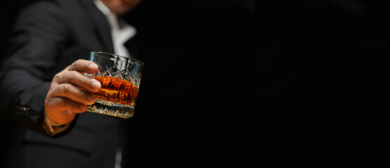 Closeup businessmen holding a glass of whiskey