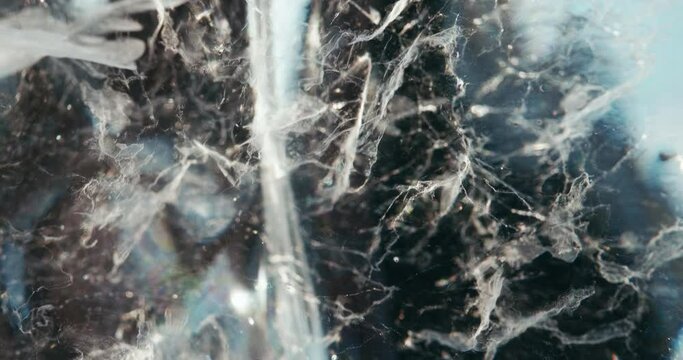 Nebula made of air bubbles in an ice block, close-up abstract background