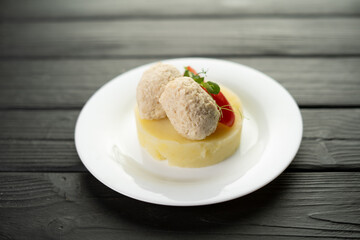 Healthy steamed cutlets with mashed potatoes on a plate on a wooden background