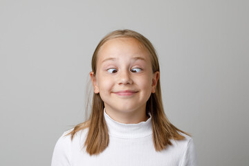 Funny kid face. Adorable girl grimacing, portrait