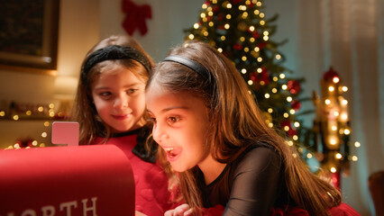 Fototapeta na wymiar Happy young girls giving their wishes to santa