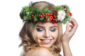 Naklejka premium Beautiful healthy young woman with party makeup, long blonde curly hairdo and Christmas decor isolated on white background. Christmas beauty