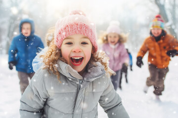 Childrens playing in snowy winter park and have fun