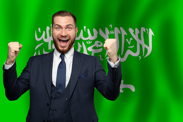 Saudi Arabian happy businessman on the background of flag of Saudi Arabia Business, education, degree and citizenship concept