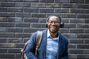 Portrait of happy dancing man with headphones listening favorite song on music streaming services.