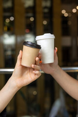 a girl holds a one-cup craft coffee cup