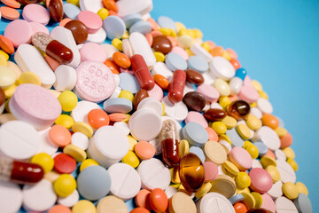 Many colorful different medicines and pills on top. The concept of medical treatment