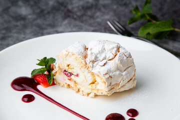 sweet sponge dessert with raspberries and powdered sugar side view