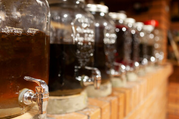 full containers of homemade wine in the storage