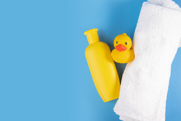Towel, baby shampoo, and rubber duck, hygiene care for newborns, adorable bath set - obrazy, fototapety, plakaty